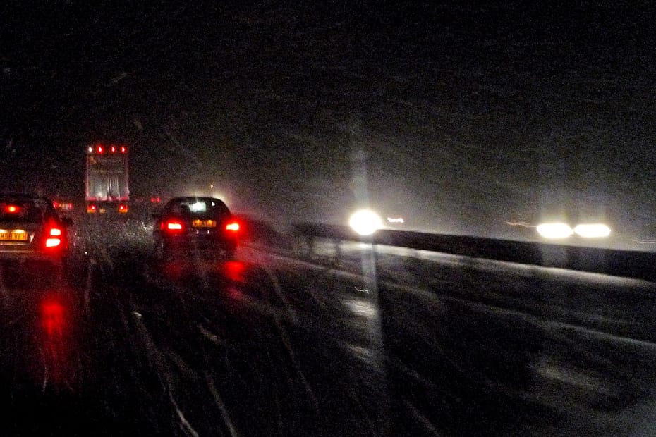 Cars driving on a wet road at night